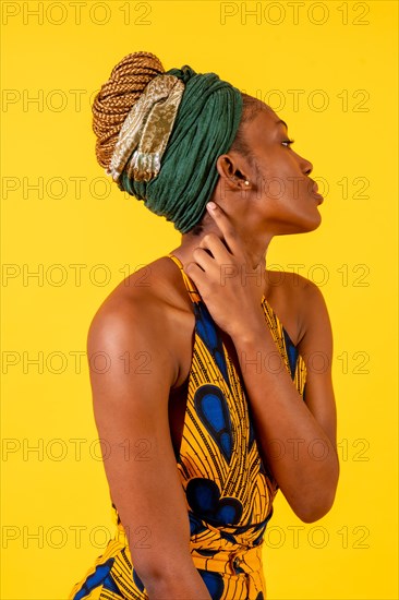 A person woman of black ethnicity with traditional costume on yellow background