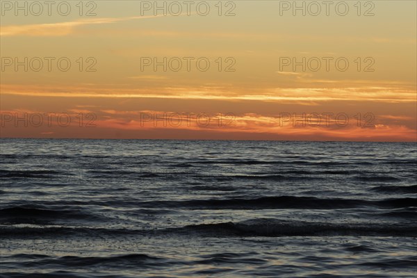 Waves on the Baltic Sea and sunset in summer on the beach of Kloogaranna