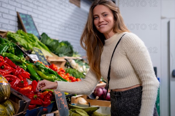 Vegetarian woman buying vegetables and greens in grocery store