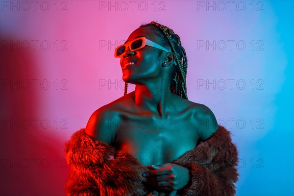 Attractive black ethnic woman with braids with red and blue led lights