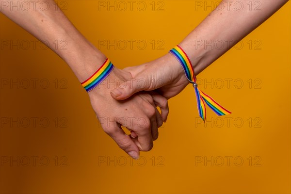 Detail of two hands of two women shaking hands with a bracelet