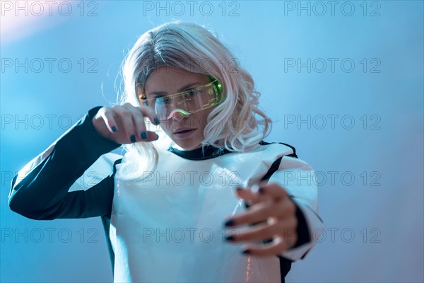 Woman with illuminated futuristic goggles