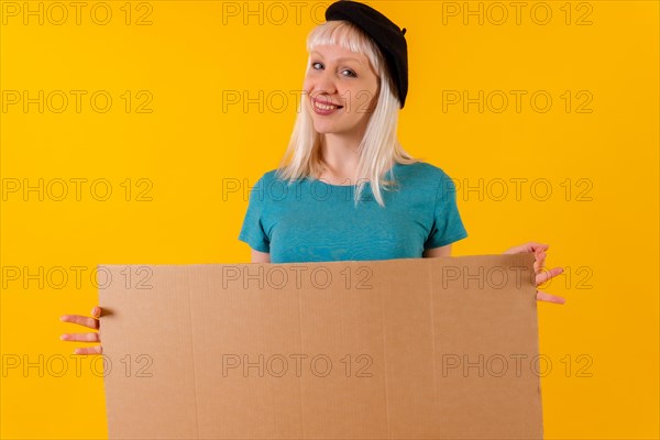 Pointing to empty cardboard advertisement poster