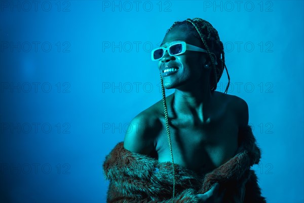 Attractive black ethnic woman with braids with blue led lights