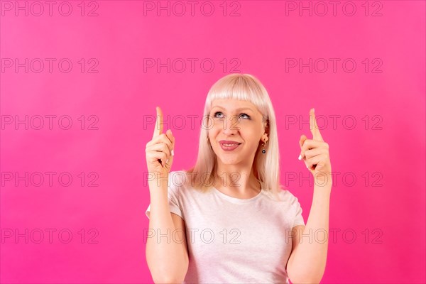 Blonde caucasian girl studio shot on pink background