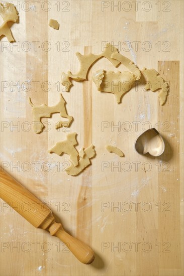 Top view of kitchen table with rests and cuts of cookie dough