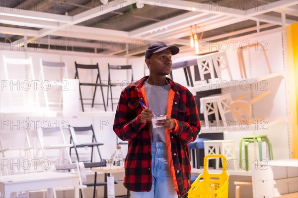 Black ethnic man shopping in a furniture store