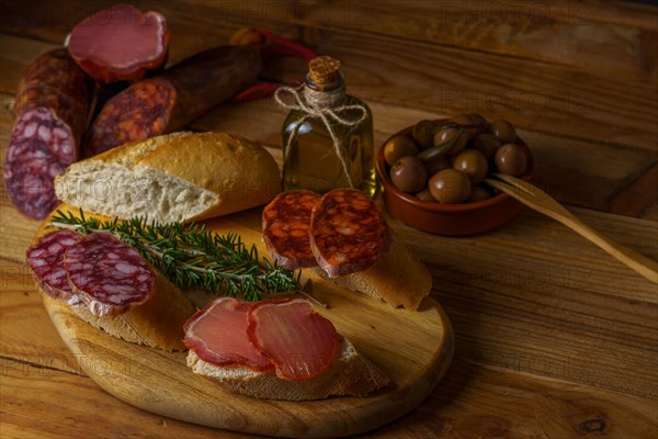 Top view of a wooden board with sausage. chorizo