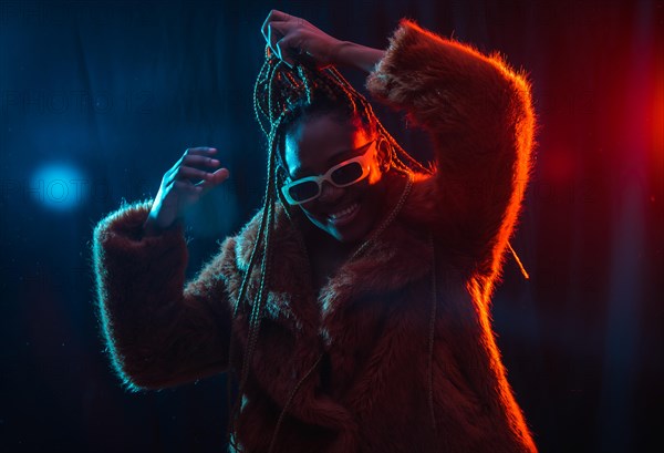 Young African woman with braids with blue and red led lights