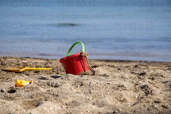 Sand toys on the beach with water surface in the background