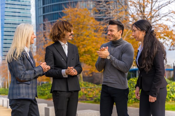 Middle-aged multi-ethnic businessmen and businesswomen enjoying good work environment