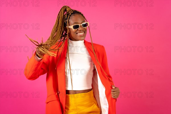 African young woman with braids on a pink background