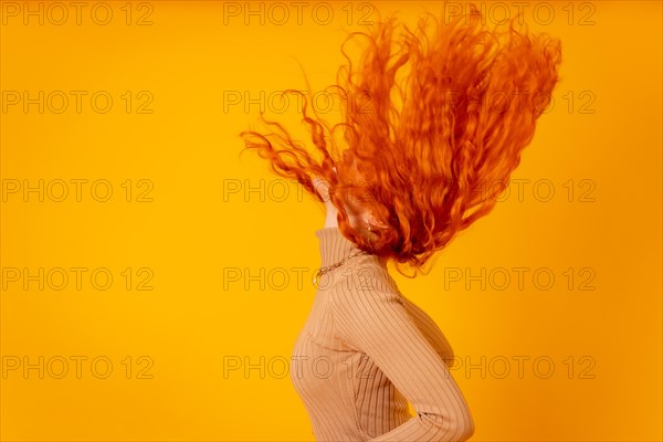 Red-haired woman on a yellow background