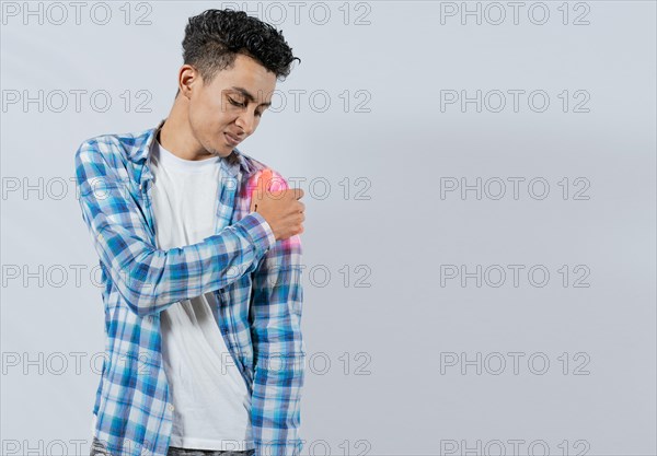 Young man with shoulder pain on white background. Shoulder and arm pain concept. People with shoulder pain on white background. Man suffering with shoulder muscle pain