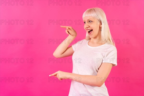 Blonde caucasian girl on pink background studio