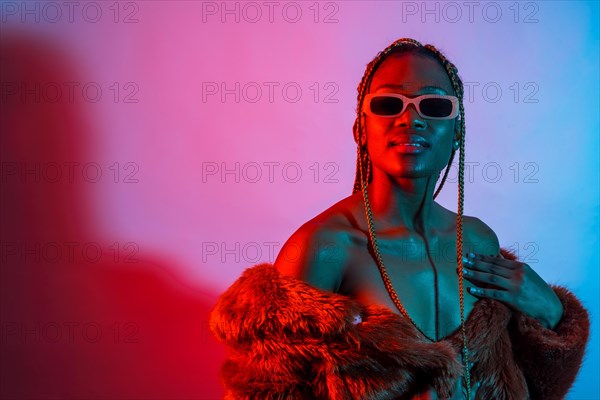 Attractive black woman with braids with red and blue led lights