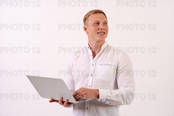 Caucasian businessman man with a laptop computer working on a white background