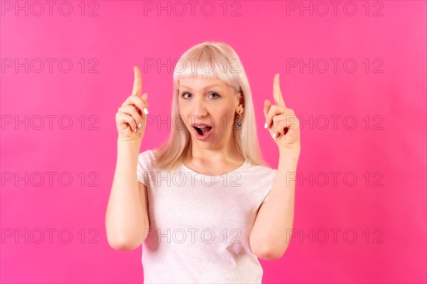 Blonde caucasian girl studio shot on pink background