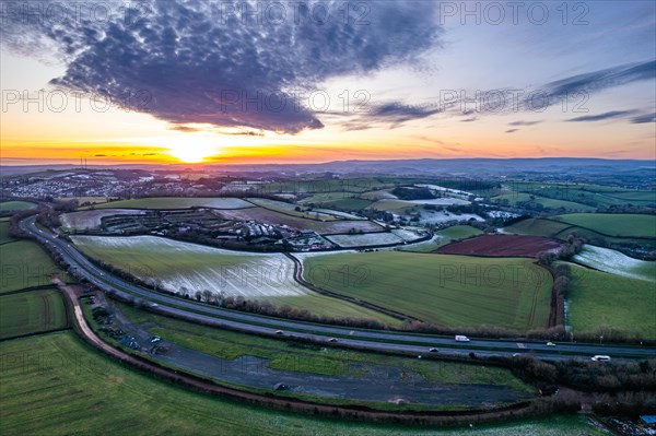 Sunset over Fields and Farms shrouded in frost from a drone