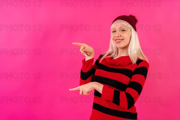 Blonde caucasian girl on pink studio background