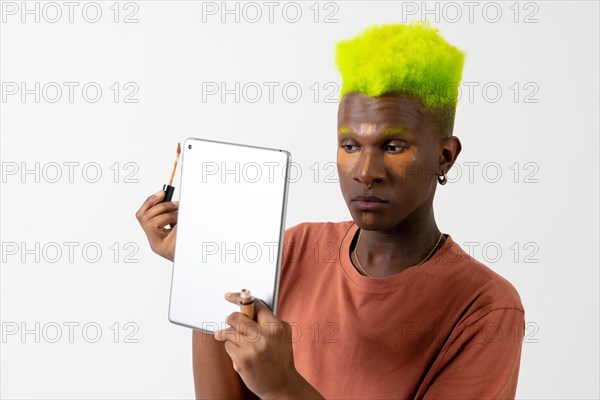 A gay black man putting on makeup