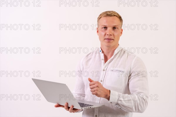 A caucasian businessman man with a laptop working on a white background