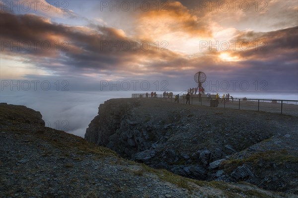 View from visitor centre of rocky coast and visitor platform with globe