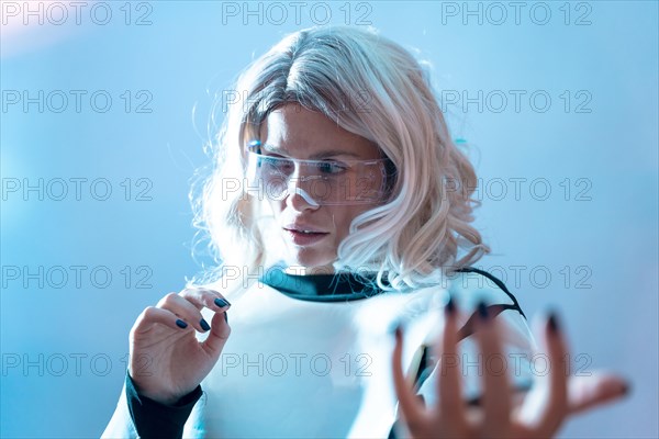 Woman with the illuminated futuristic glasses and white hair
