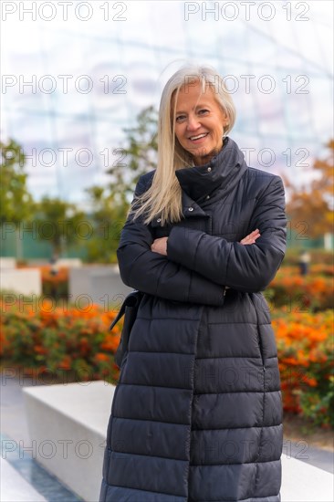 Corporate portrait of white-haired middle-aged businesswoman