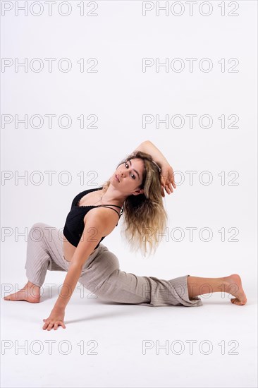 Young dancer in studio photo session with a white background