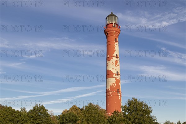 Weathered lighthouse in the evening light against a blue sky on Pakri Peninsula