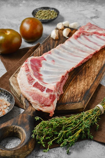 Raw fresh lamb breast and flap on wooden cutting board