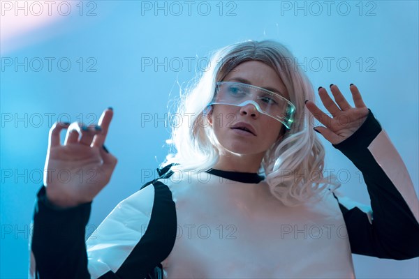 Woman looking through the illuminated futuristic glasses