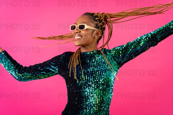 African young woman with party braids on a pink background