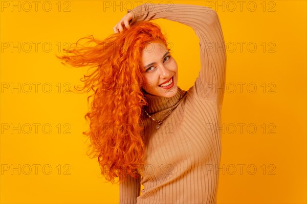 Red-haired woman on a yellow background
