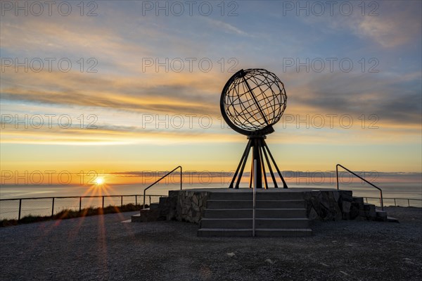 Steel globe at the North Cape under the midnight sun