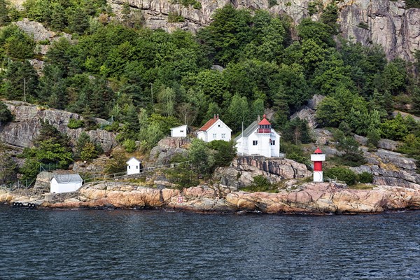 Listed red and white lighthouse on the cliffs of the Odderoya peninsula