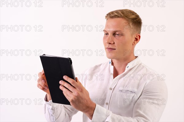 Caucasian businessman man with a tablet working looking at email on a white background