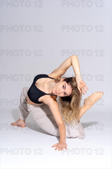 Young dancer in a studio photo session with a white background