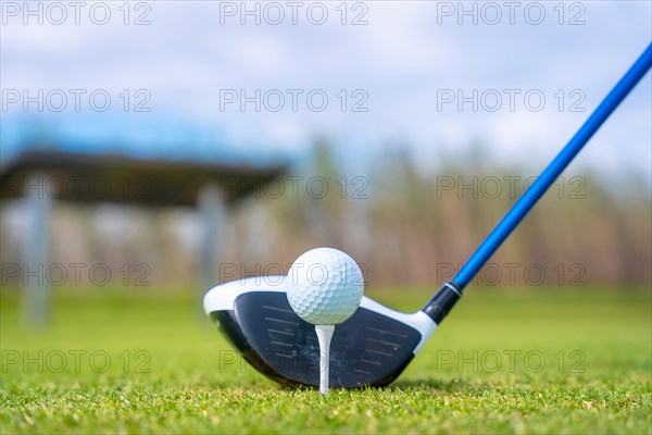 Man playing golf at golf club by a lake