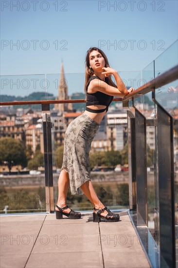 Portrait of a young woman on a hotel terrace looking at the city from above