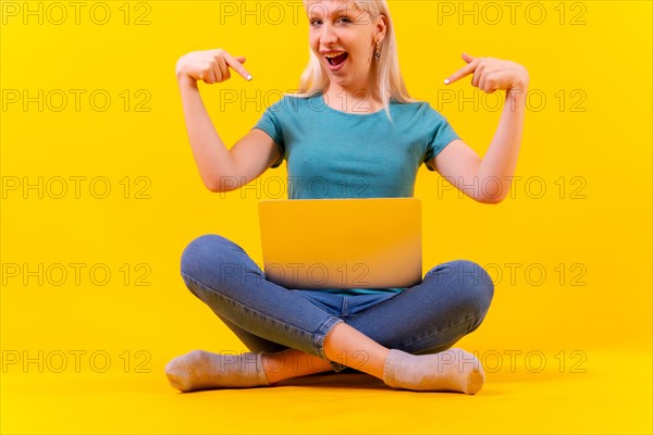 Sitting with laptop pointing