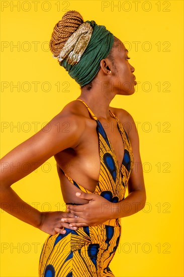 African young woman in the studio on a yellow background