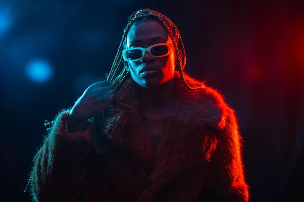 Woman of black ethnicity with braids with blue and red led lights