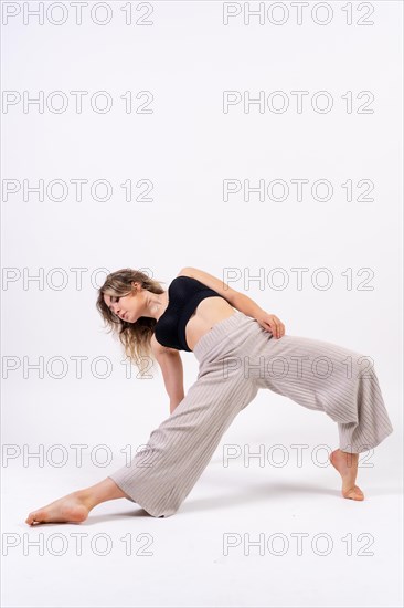 Young dancer in studio photo session with a white background