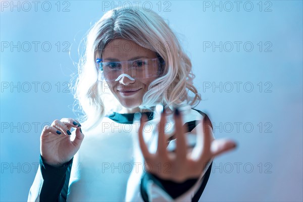 Woman with illuminated futuristic glasses and white hair