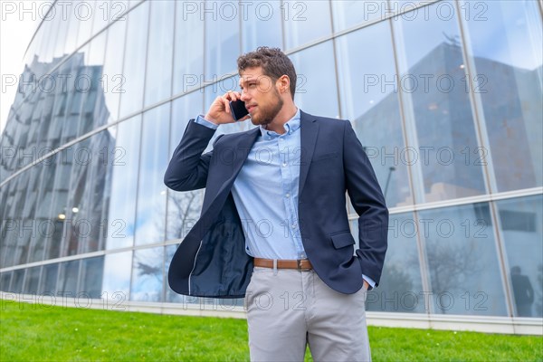 Businessman or finance man talking on the phone outside the office