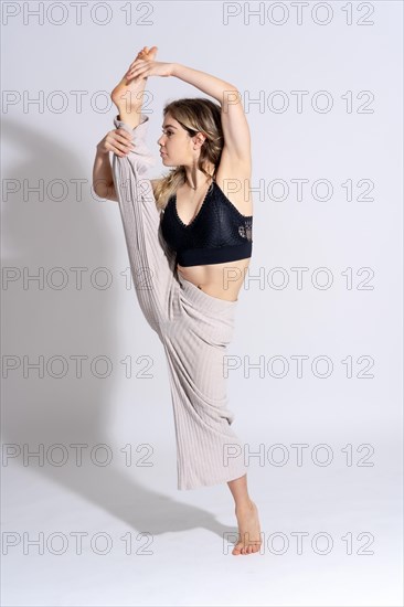 Young dancer in studio photo session with a white background