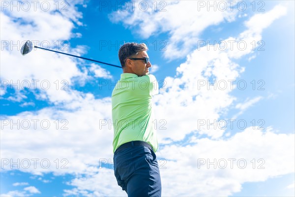 Detail of a golf player on a professional golf course hitting the ball with the stick driver