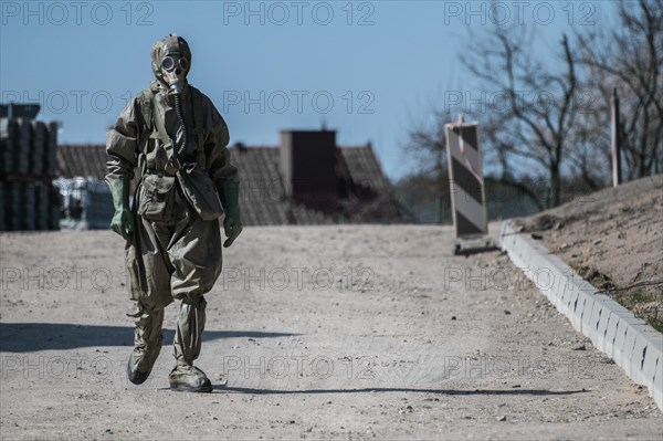 Man dressed in chemical suit walking on the street at the begining of COVID-19 pandemic